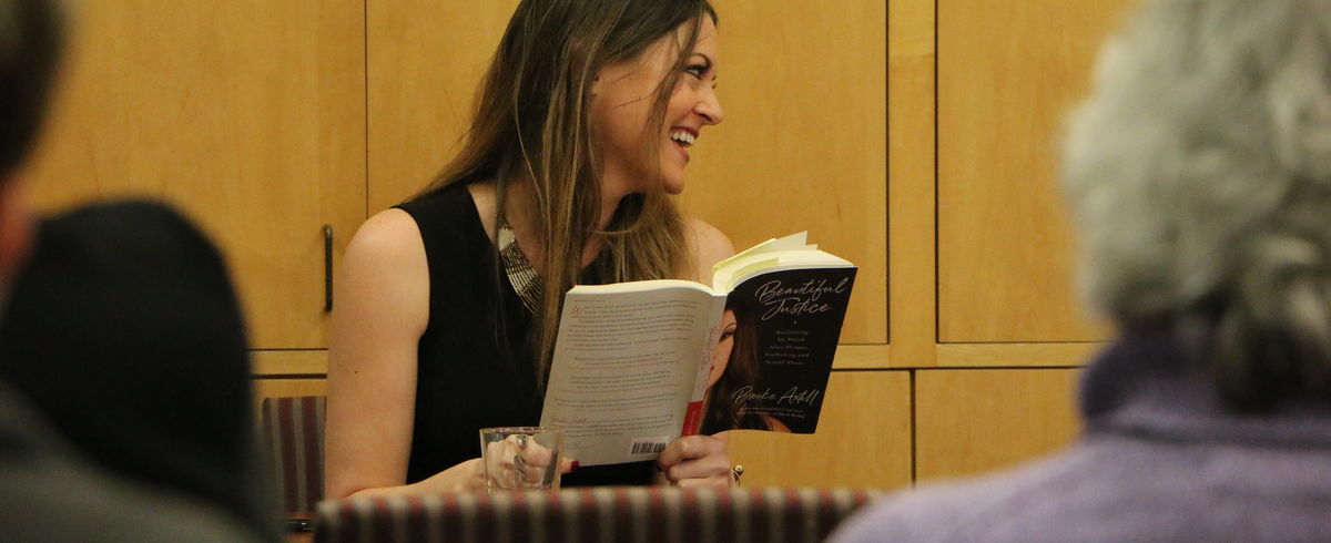 Brooke Axtell laughs while reading from her book Beautiful Justice.