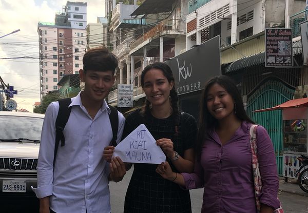 Three young people standing on a street