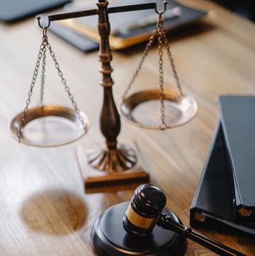 scale and gavel on a table near books
