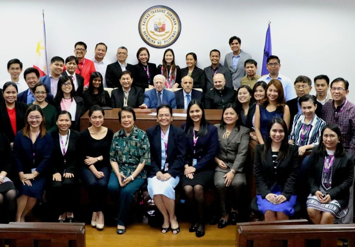 A large group of people in the Phillipines Judiciary posing for camera