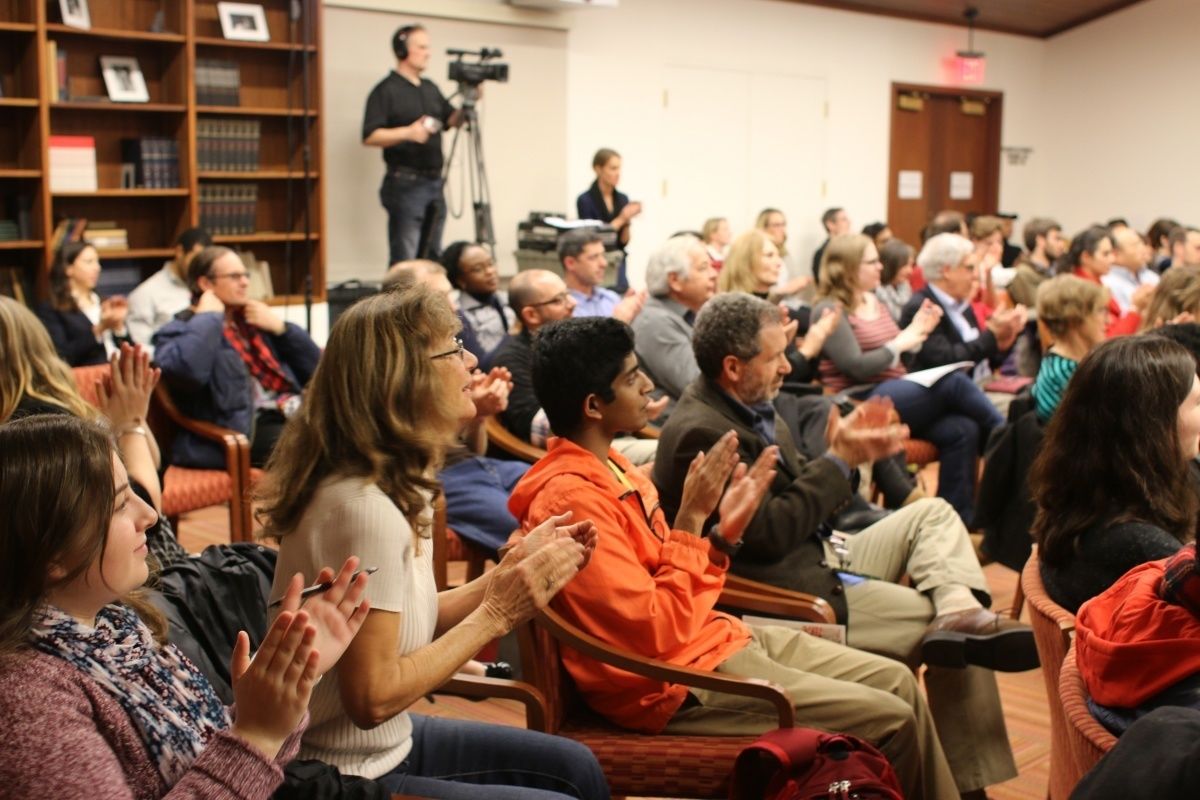 Audience at a Center event claps for the speaker.