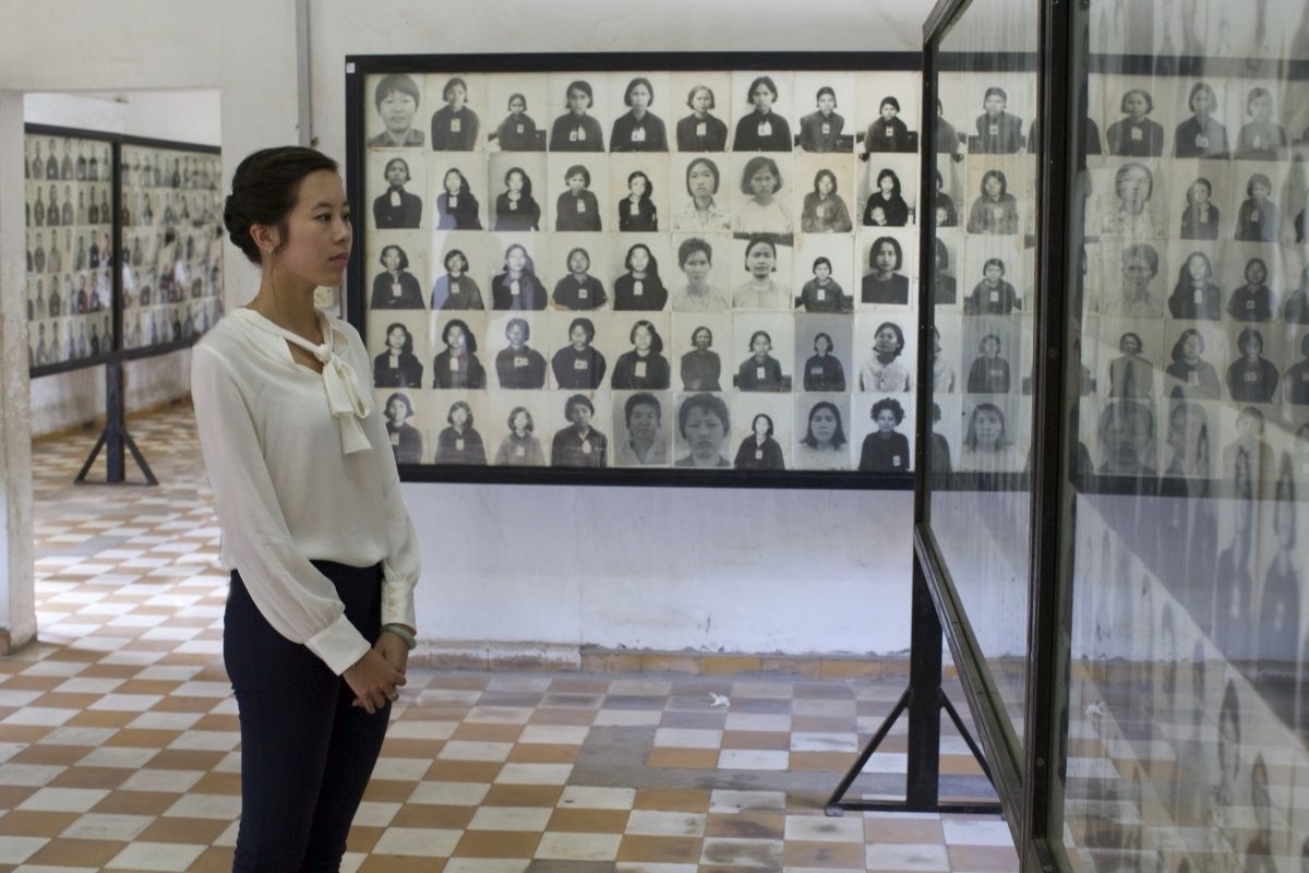 Quito Tsui stands in front of Tuol Sleng Museum exhibit.